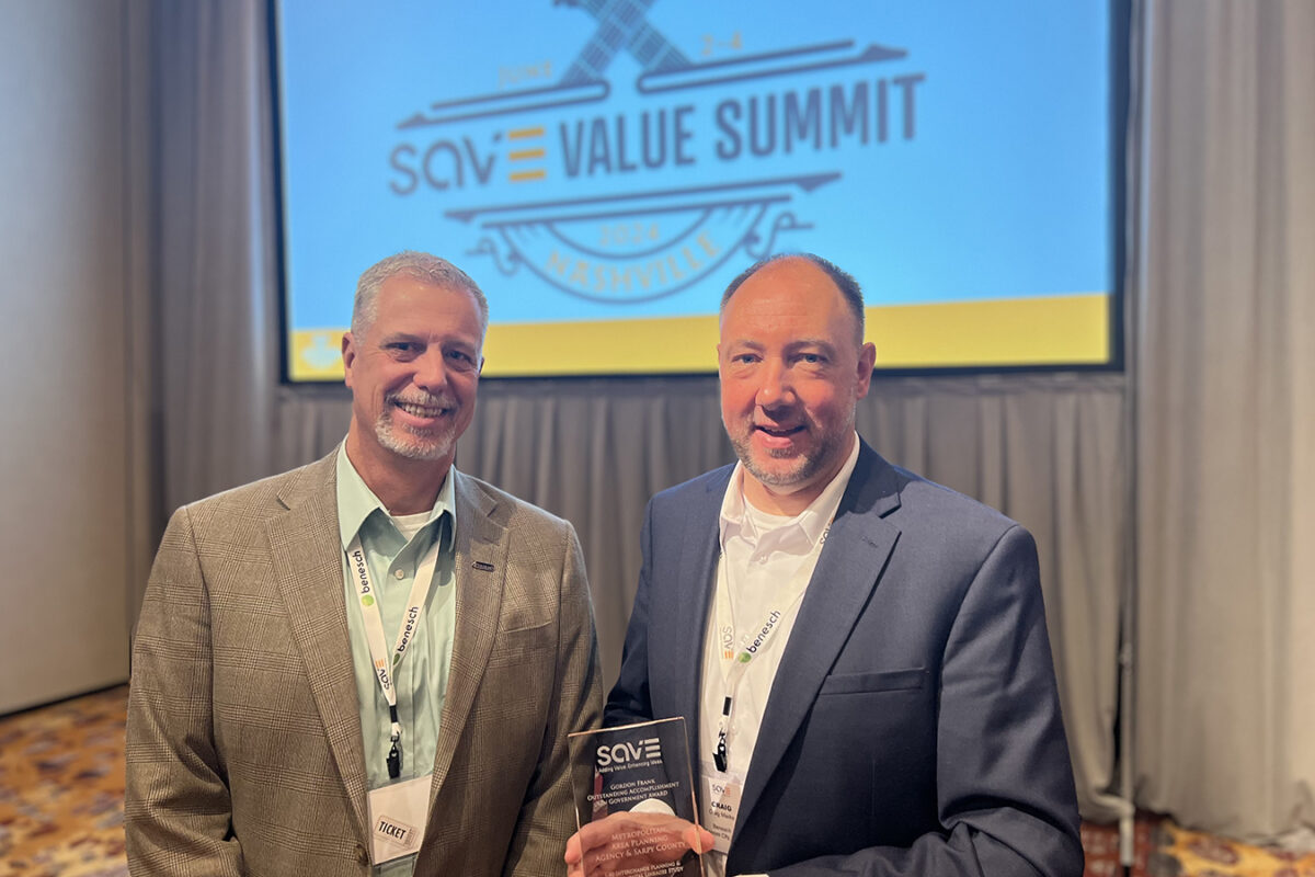 Photo of Chuck Bartlett and Craig Mielke, of Benesch, holding the 2024 SAVE Award that was given to the I-80 PEL study during the 2024 SAVE International conference