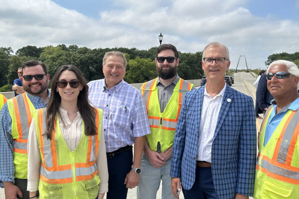 photo of Benesch construction management team members standing on the new Longmeadow Parkway during a ribbon cutting ceremony