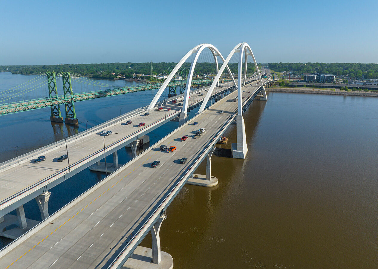 A photo from above of the two I-74 Mississippi River Bridge with car traffic