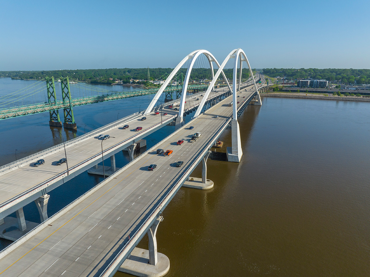 A photo from above of the two I-74 Mississippi River Bridge with car traffic