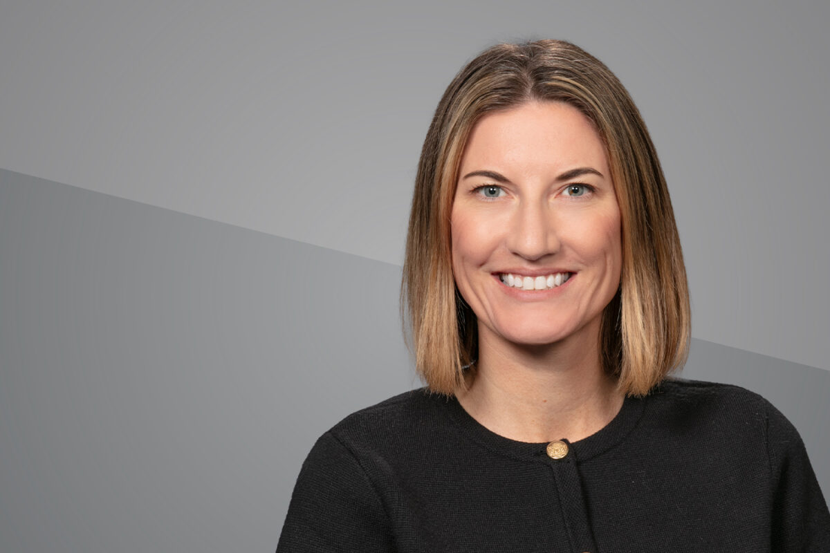 Headshot of Elisabeth Schuck with a grey background