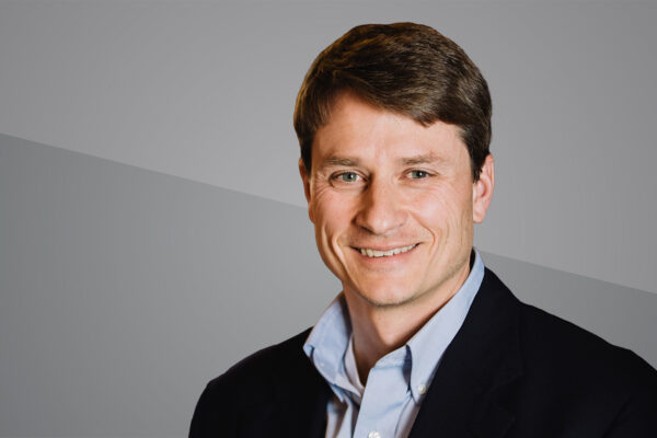 Headshot of Erik Hammarlund on grey background