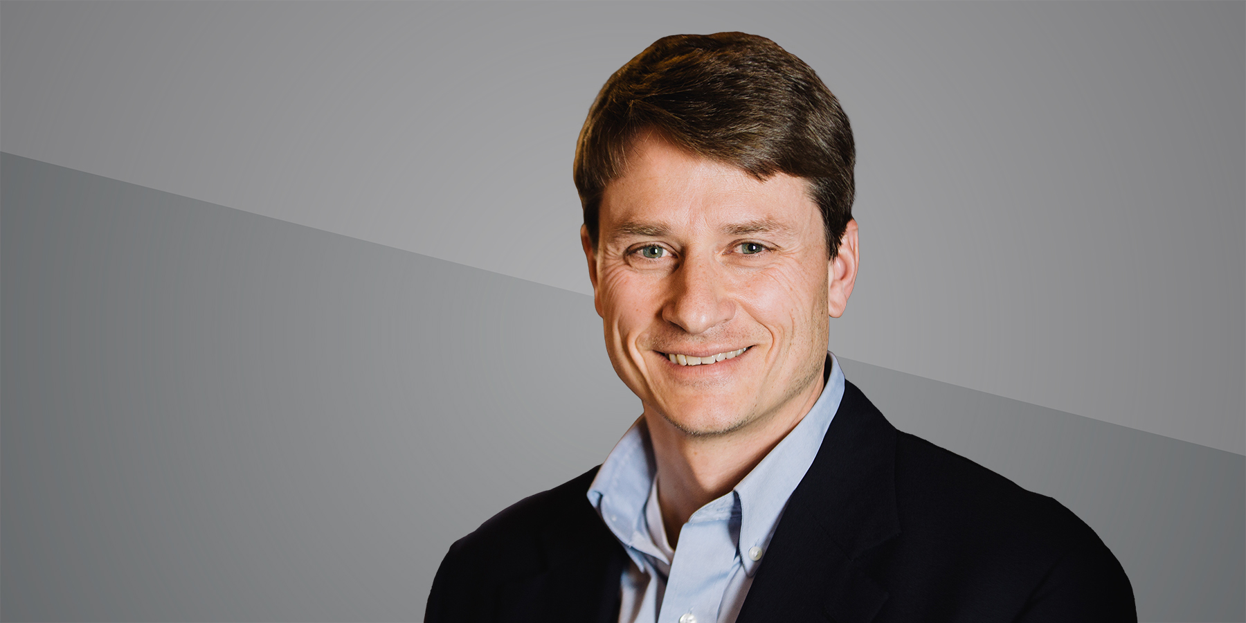 Headshot of Erik Hammarlund on grey background