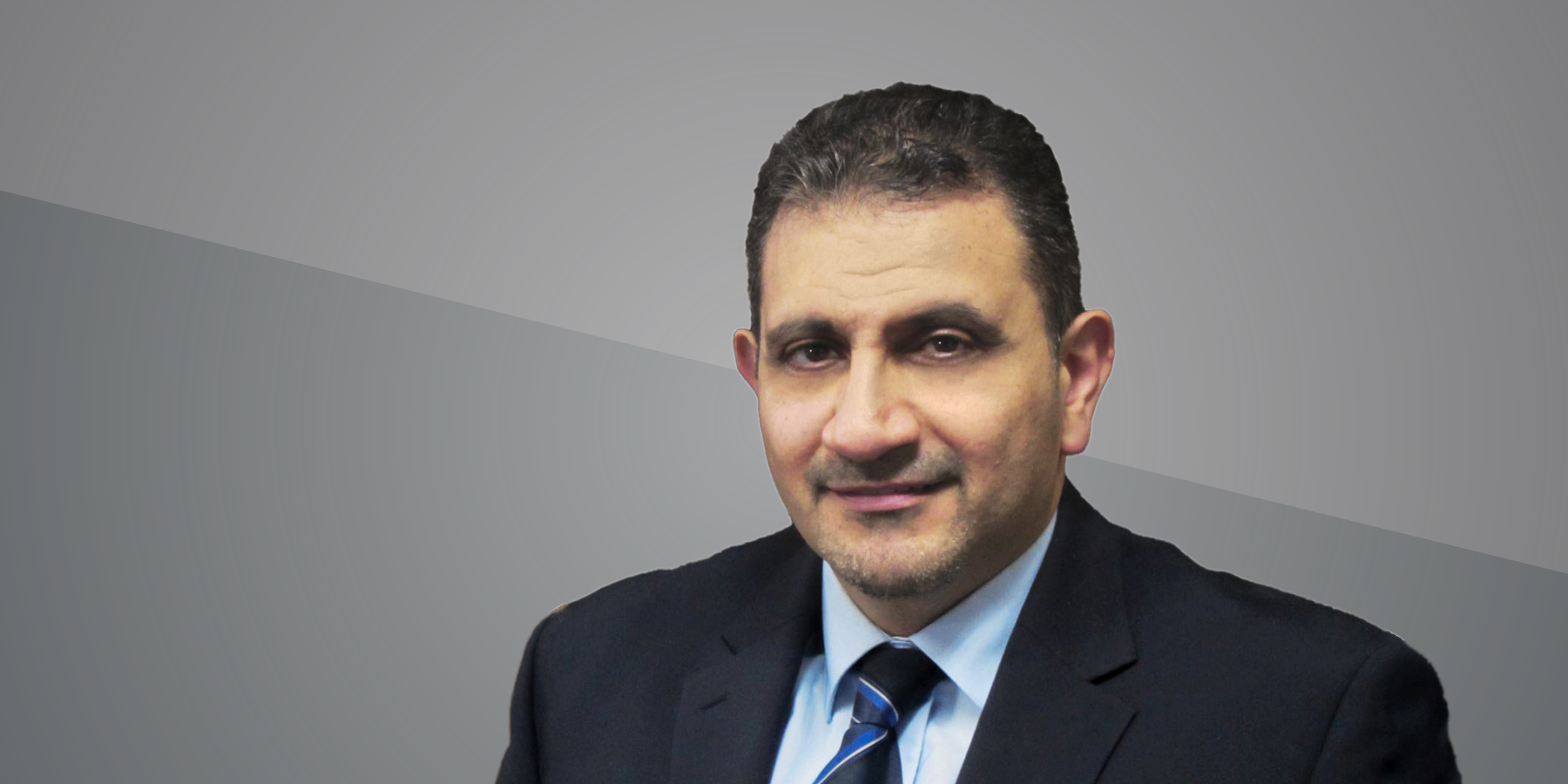 Headshot of Ihab Darwish on grey background