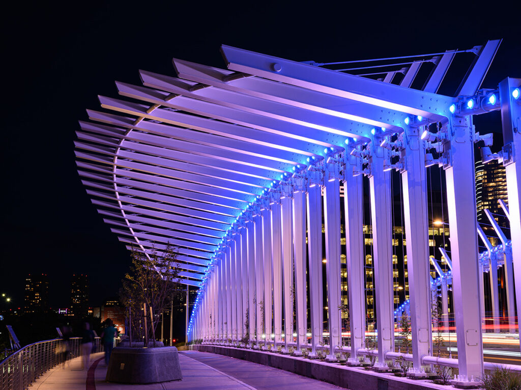 Nighttime view of bridge with purple lighting