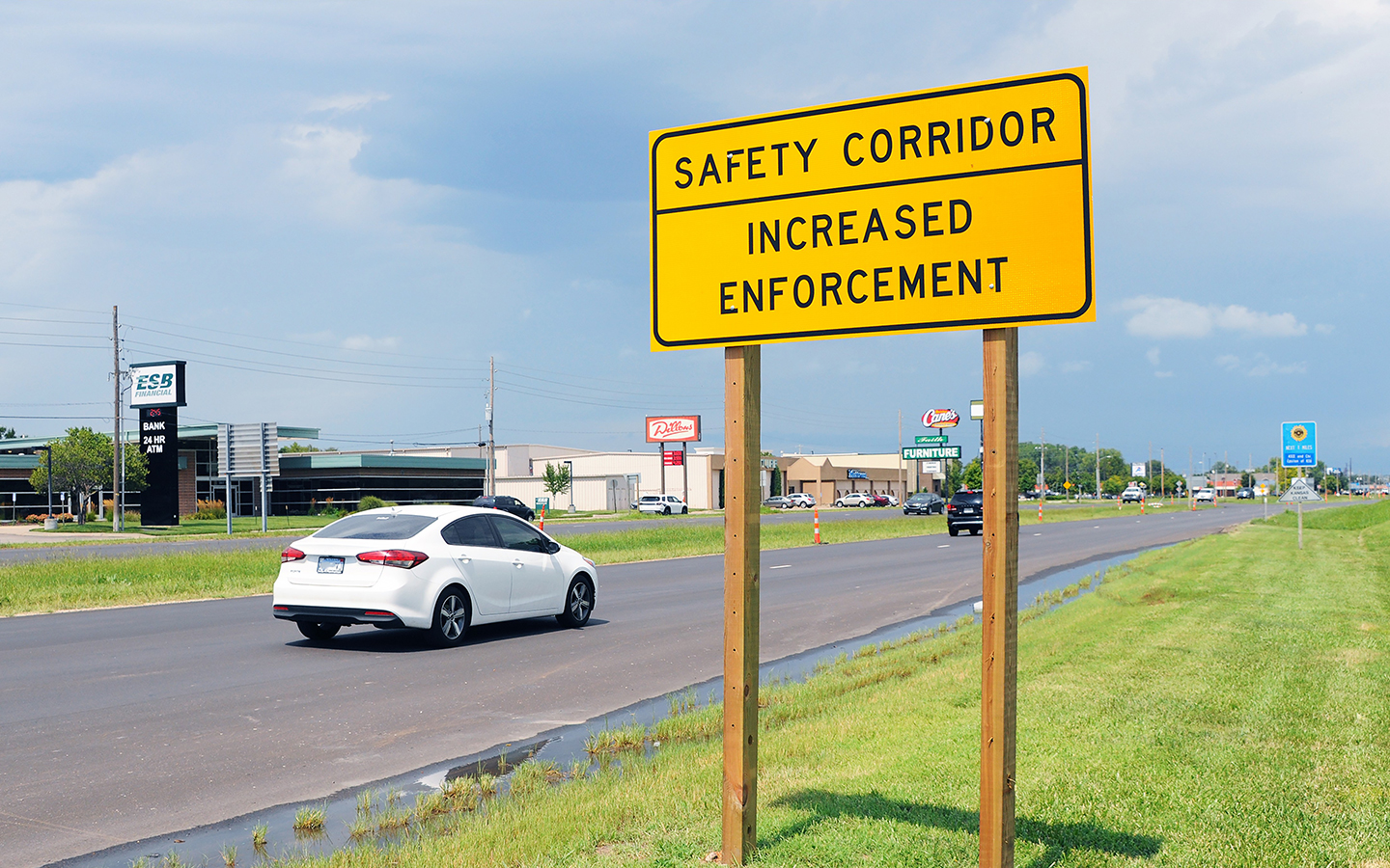 Cars on Kansas highway with sign indicating safety corridor