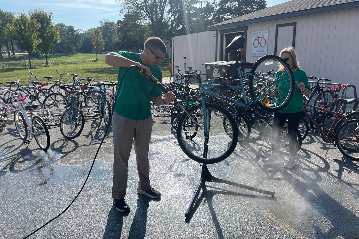 Employees wash bikes for Lincoln Bike Kitchen