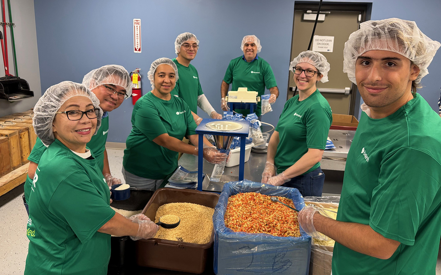 Benesch employees gathered assembling meals for Feed our Starving Children