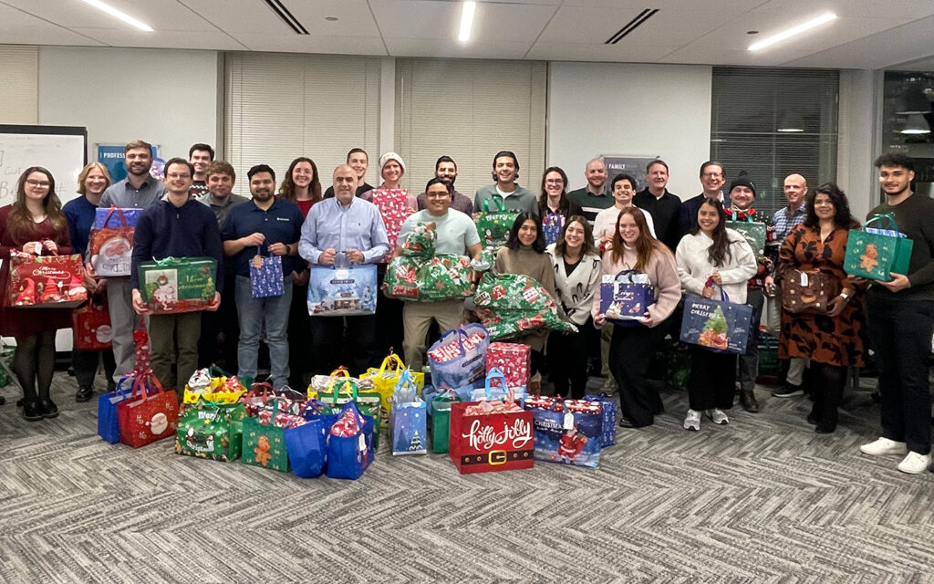 Group of Benesch employees with wrapped gifts