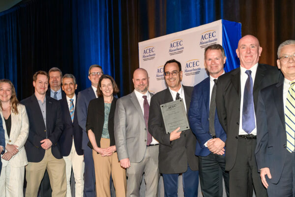 Project Team on stage holding award