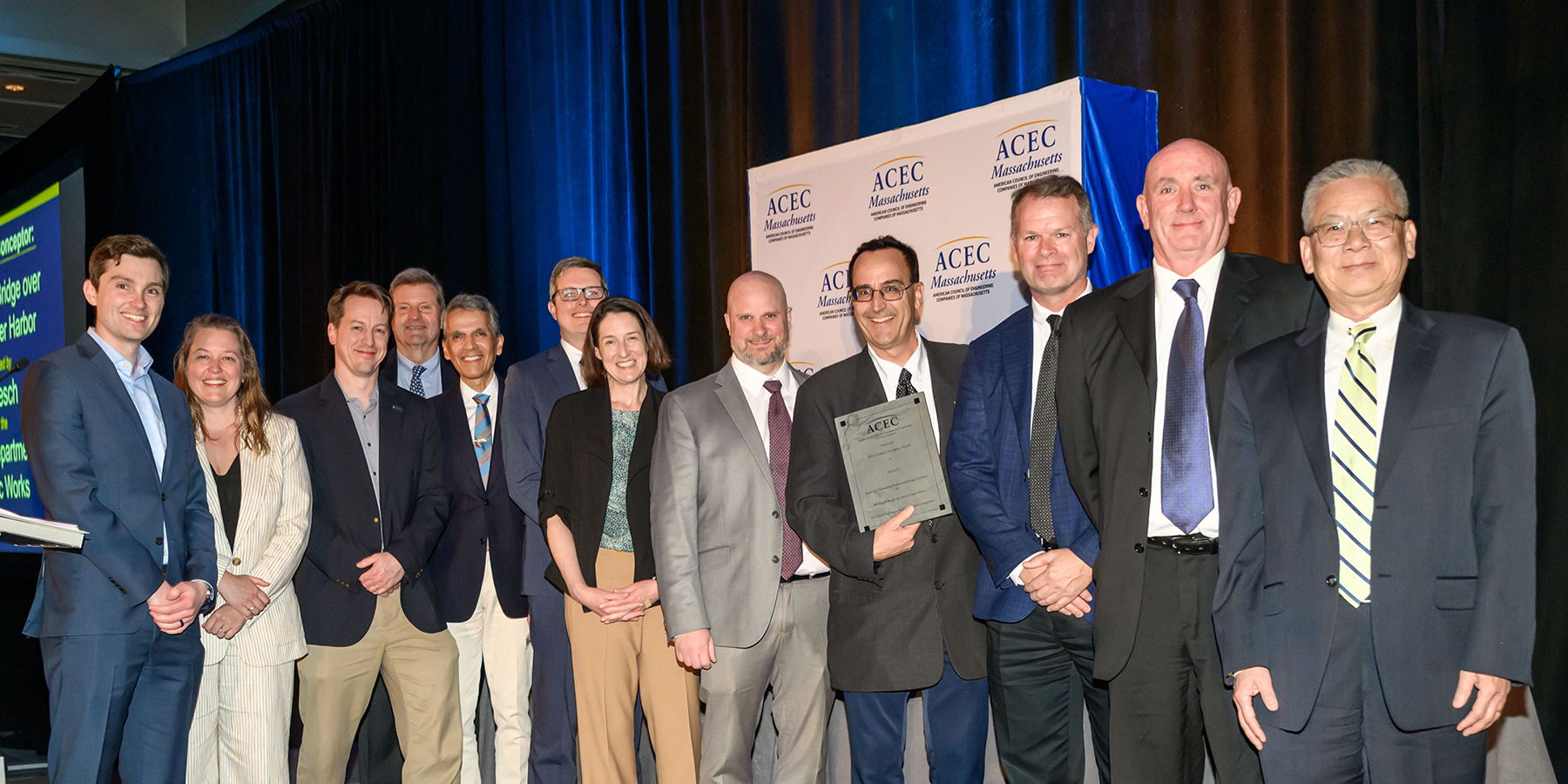 Project Team on stage holding award