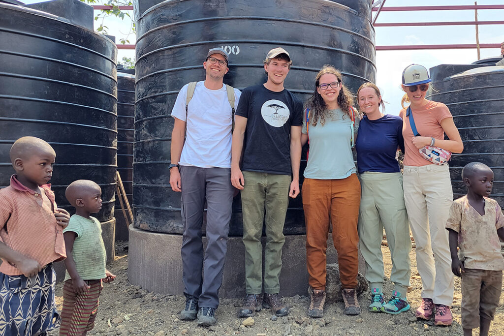 image of Benesch engineer with team members and local children during an Engineers without Borders trip
