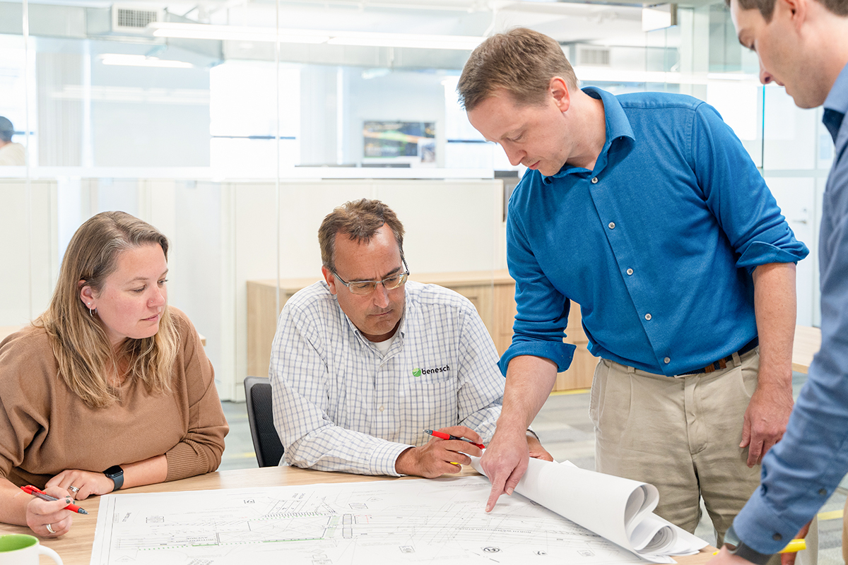 Benesch team members reviewing a set of plans in a conference room