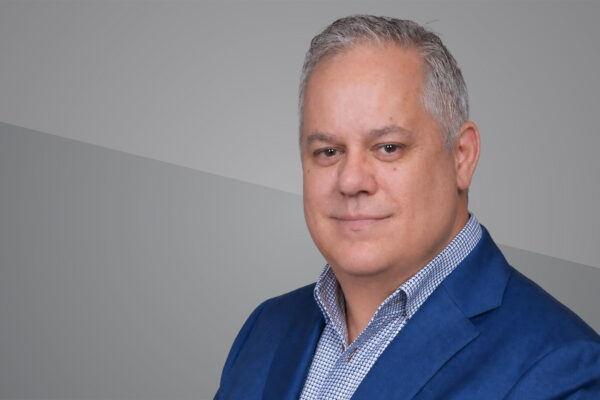 Headshot of Dean Morrison on grey background